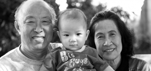 senior grandparents holding grandchild